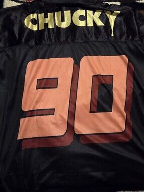 Universal "Chucky" Black Jersey with Gold and Coral Number 90